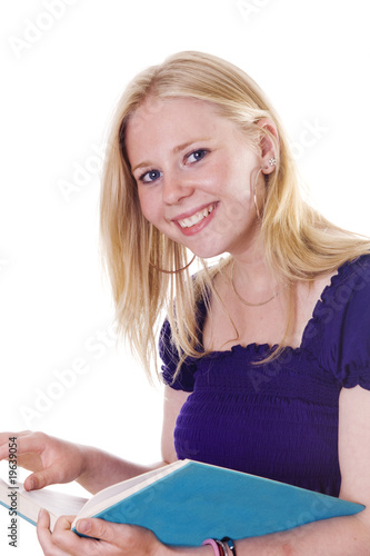 Photo: Blonde girl looking up from study book smiling Blonde girl looking up from study book smiling
