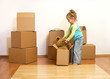 Excited little girl unpacking in her new home