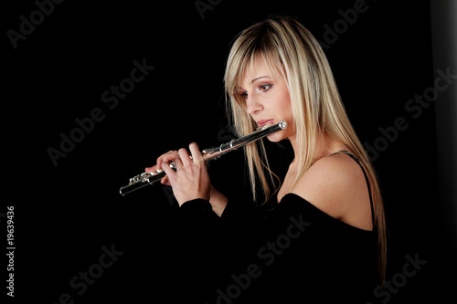 Portrait of a woman playing transverse flute Portrait of a woman playing transverse flute