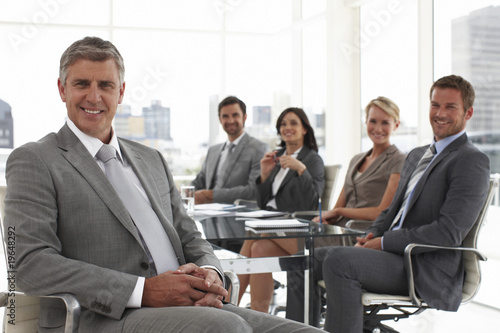 Photo: Senior executive with his team Senior executive with his team