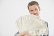 Man with a fan made of dollars