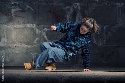 Photo: Hip hop dancer in modern style over brick wall Hip hop dancer in modern style over brick wall