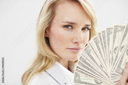 Photo: Young woman with a dollars fan Young woman with a dollars fan