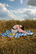 Beautiful slavonic girl on picnic in wheat field