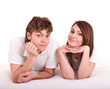 Happy young couple on bed. Isolated.