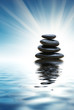 Stack of zen stones reflects in pure blue water Stack of zen stones reflects in pure blue water