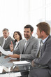 Businesspeople sitting at a glass table