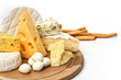 Assortment of various types of cheese on wooden board on white b Assortment of various types of cheese on wooden board on white b