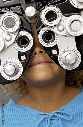 Photo: African American girl getting eye exam African American girl getting eye exam