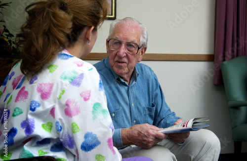 Photo: Nurse talking with senior man Nurse talking with senior man