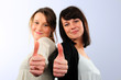 Foto: two young woman with thumb up two young woman with thumb up