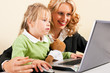 Busineswoman and mother showing kid the internet