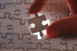 Photo: Hand placing missing puzzle piece Hand placing missing puzzle piece