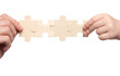 Foto: mens and childs hands holding set of puzzles mens and childs hands holding set of puzzles