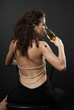 Rear view of sexy girl drinking wine
