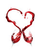Red wine spilling and forming heart shape