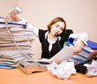 Young businesswoman with tons of documents