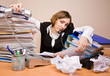 Young businesswoman with tons of documents