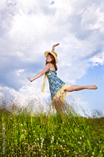 Photo: Young girl dancing in meadow Young girl dancing in meadow