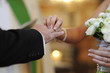 Bride putting a ring on groom's finger