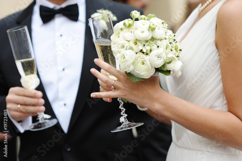 Photo: Bride and groom holding champagne glasses Bride and groom holding champagne glasses