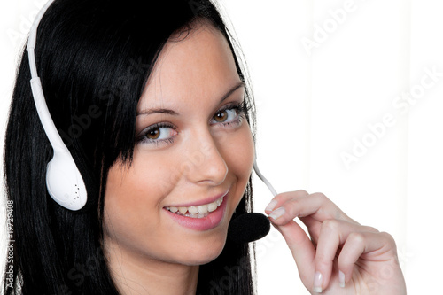 Photo: Frau mit Headset im Kunden Service. Telefon Hotline Frau mit Headset im Kunden Service. Telefon Hotline