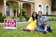 Happy African American Couple Beside House For Sale Sign