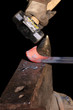 Blacksmith working on forming rail