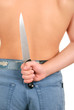 Hand hides knife for back