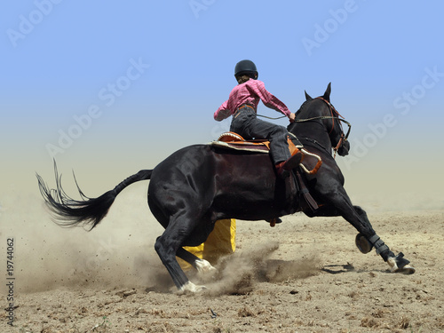 Photo: Cowgirl Rounding a Drum in the Barrel Race Cowgirl Rounding a Drum in the Barrel Race