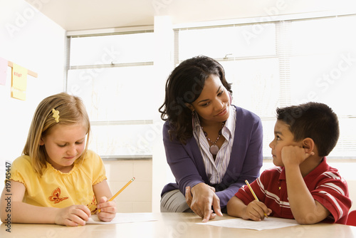 Photo: Teacher Helping Students With Schoolwork Teacher Helping Students With Schoolwork