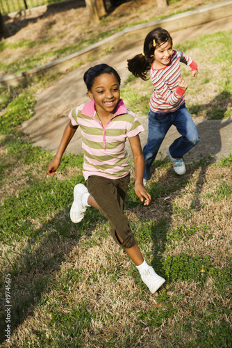 Photo: Young Girls Running on Grass Young Girls Running on Grass
