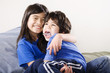 Photo: Big sister holding her disabled little brother Big sister holding her disabled little brother