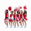 Smiling female cheerleaders posing against white