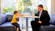 Dad and little son eat cake in cafe