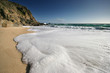 Foaming wave on golden sands Porthchapel West Cornwall UK