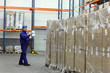worker in blue uniform counting stocks in warehouse worker in blue uniform counting stocks in warehouse