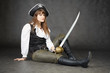 Young beautiful woman in clothes of pirate with sabre