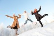 Happy girls jumping in the snow