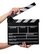 Two hands with a movie clapper board open. Isolated over white b