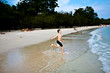 young happy boy with brown hair enjoys the beach