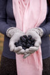 A young woman holding a handful of blackberries