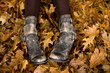 Woman's legs and feet in autumn leaves