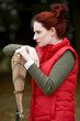A young woman leaning on a rake