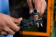 Hands Holding a Tool Measuring a Pipe
