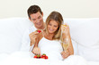 Lovers drinking Champagne with strawberries