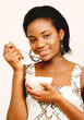 Beautiful black teenager eating cornflakes