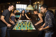 Photo: Group of People Playing Foosball Group of People Playing Foosball