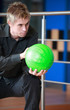Portrait of young man preparing to play bowling