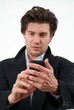 Ein Geschäftsmann schaut auf sein Handy. Ein Geschäftsmann schaut auf sein Handy.